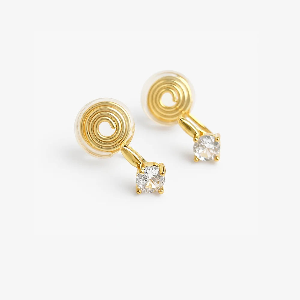 Gold solitaire CZ clip-on studs showing the spiral U-Type clip and clear resin cushion