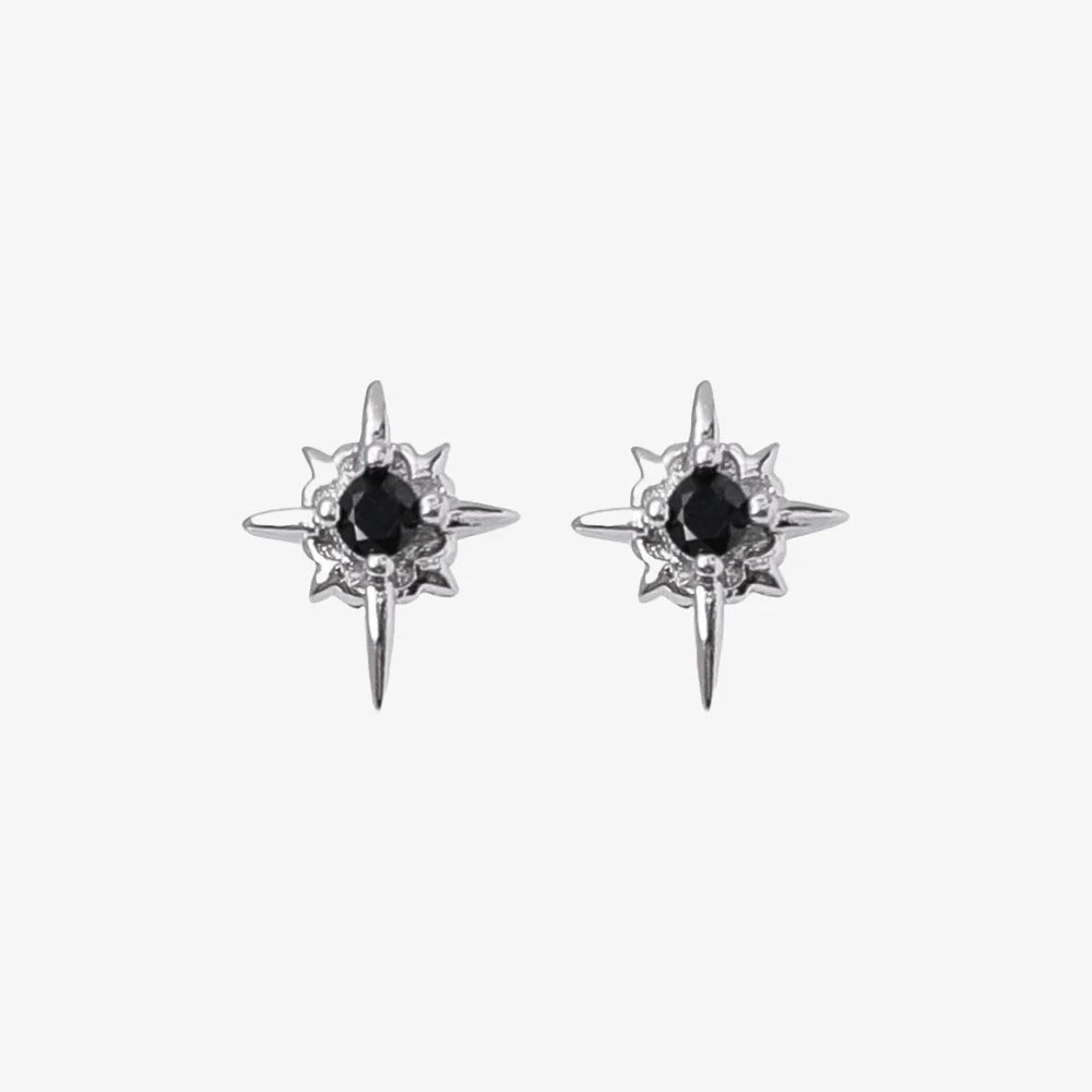 A pair of Starlight Obsidian magnetic stud earrings, featuring a multi-pointed star design with a black cubic zirconia center, isolated on a white background.