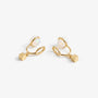 Minimalist gold cube clip-on earrings showing the open C-Type clip and resin pad
