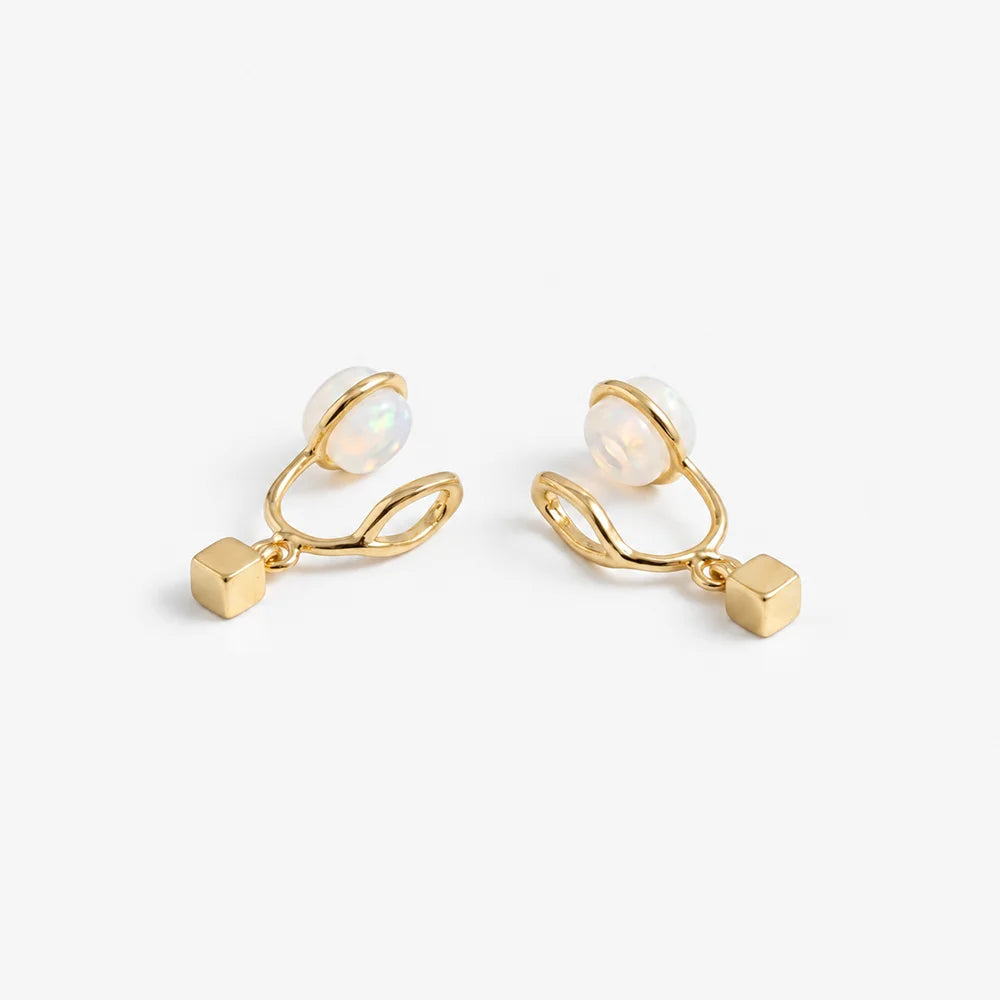 Minimalist gold cube clip-on earrings showing the open C-Type clip and resin pad