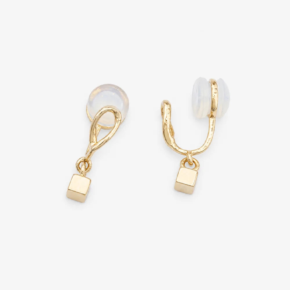 Close-up of the twisted gold wire loop and cube charm on C-Type clip-on earrings