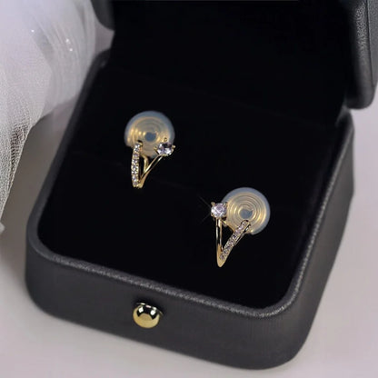 Detail of unique 18K gold plated clip-on earrings showing brilliant zircon stone and pavé crystal ribbon