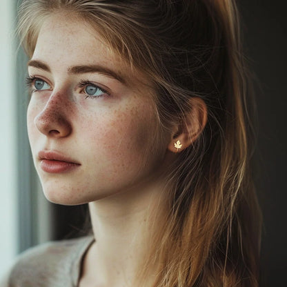 Model wearing Sterling Silver Maple Leaf Cuff Earrings in Gold, showcasing the rich and nature-inspired design.