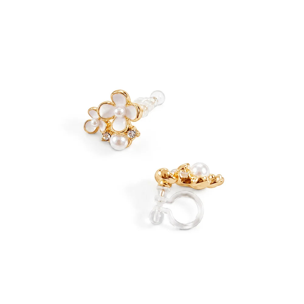 A pair of gold and white pearl stud earrings on a clean white background, showing both the front floral view and the clip on closure view.