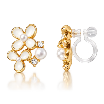 A pair of gold hoop earrings with white pearl flower motifs and small clear crystal accents, shown on a clean white background with one earring facing forward and the other angled to show the post and clear elastic clip on back.