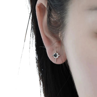A close-up of a woman's ear wearing a celestial magnetic star earring, demonstrating its subtle yet edgy appearance.