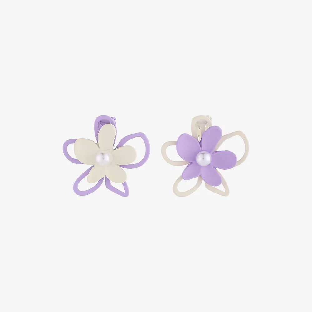 Pastel Petals Mismatched Clip-On Earrings in purple and cream with pearl centers, front view on white background